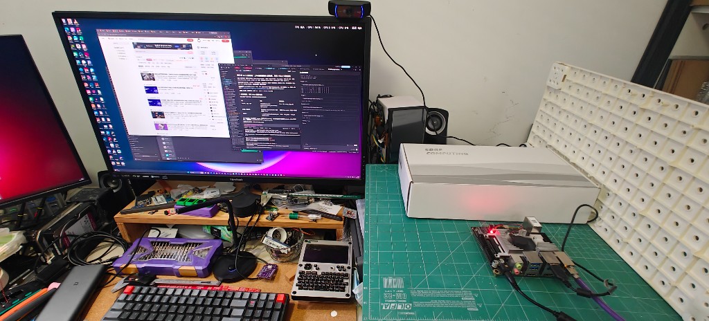 Desk setup: a C920 on top of the monitor, the Rhino Pi X1 on the mat next to it