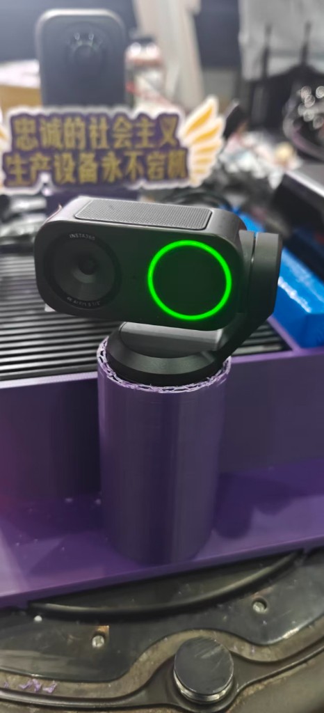 Insta360 Link 2 Pro — gimbaled webcam with active green tracking ring, mounted in the printed PLA collar I designed for the chassis