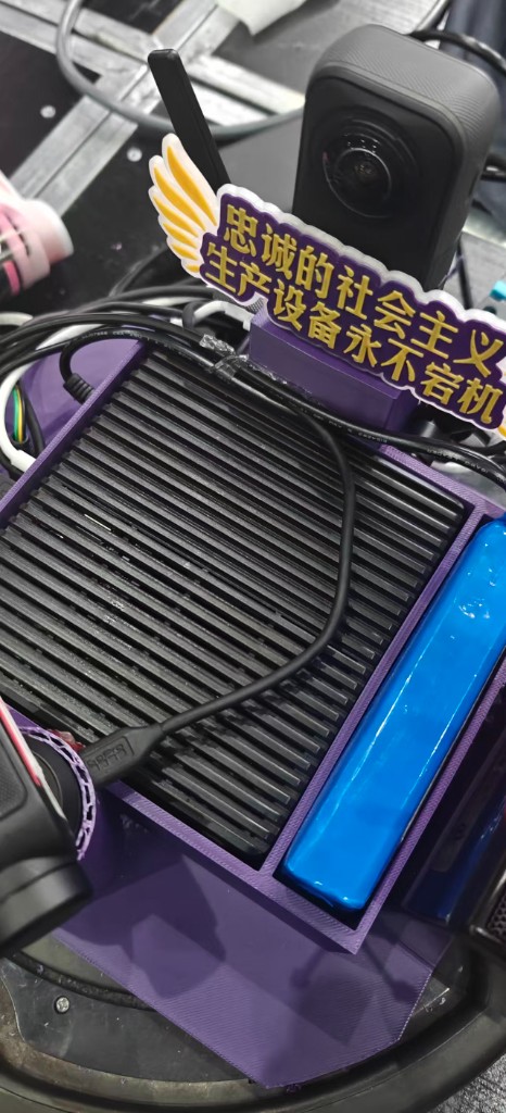 reComputer J4012 — Jetson Orin NX, fanless heatsink with the obligatory "Loyal Socialist Production Equipment Never Crashes" sticker
