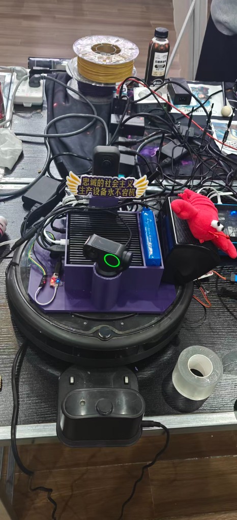 The actual robot — Insta360 X5 + Link 2 Pro + reComputer J4012 + USB speaker + a small lobster, all riding a Roomba chassis